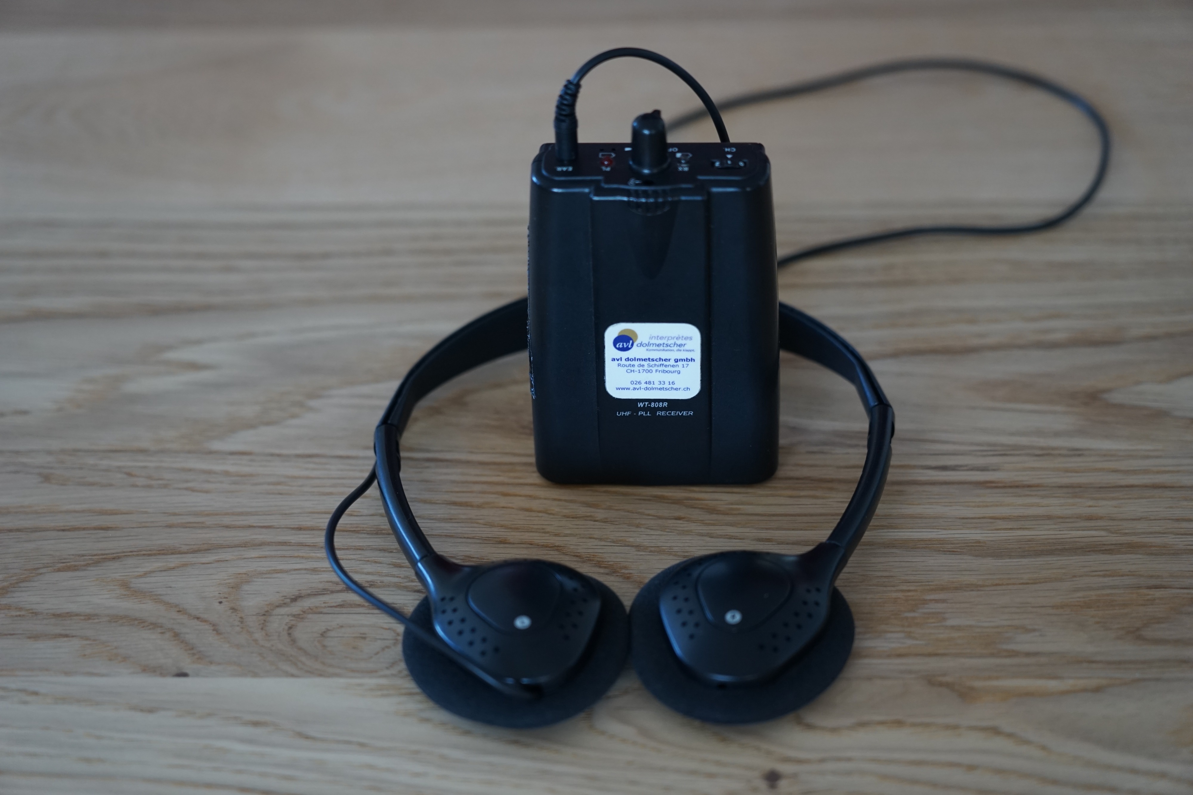 The transmitter includes a headset microphone. The interpreters use this microphone to convey what is being said to the foreign-language audience.